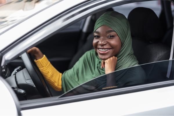 Young woman sitting in car